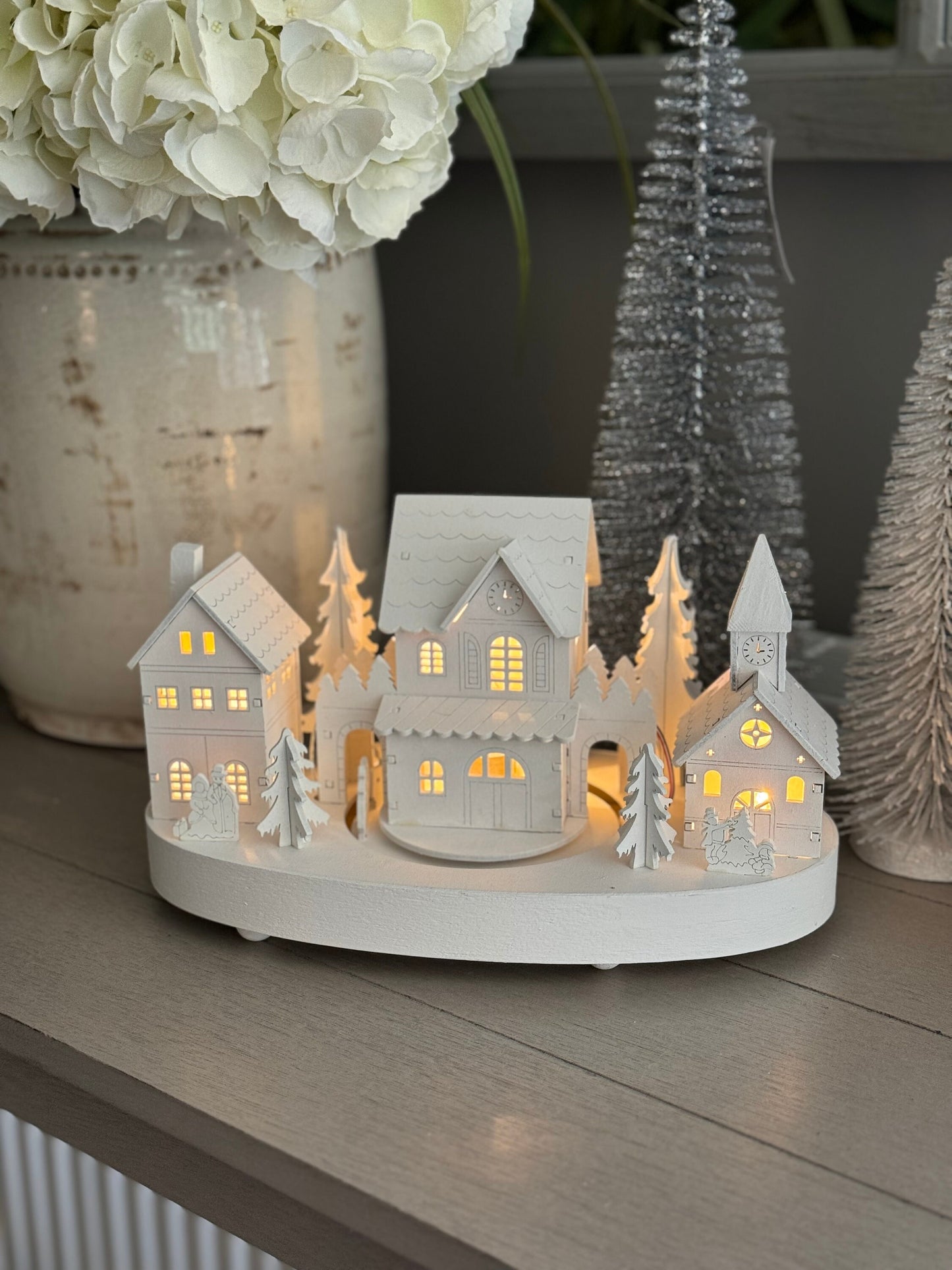 White Wooden Christmas Village Scene With Moving Train And Lights.
