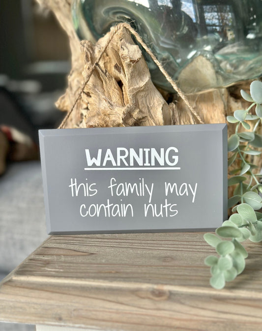 Warning, This Family May contain Nuts Humorous Sign